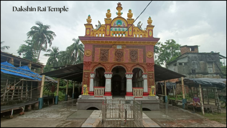 Exterior view of the colorful Dakshin Rai Temple at Dhapdhapi showing tiger statues and terracotta carvings.